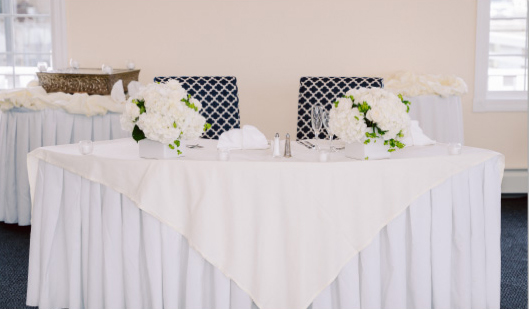 Sweetheart table with floral centerpieces.